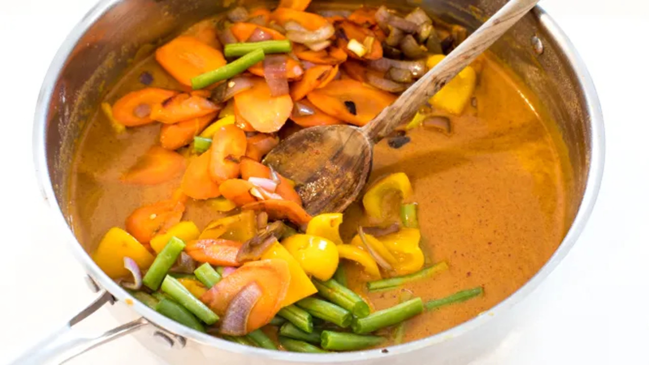 Adding The Vegetables To The Curry