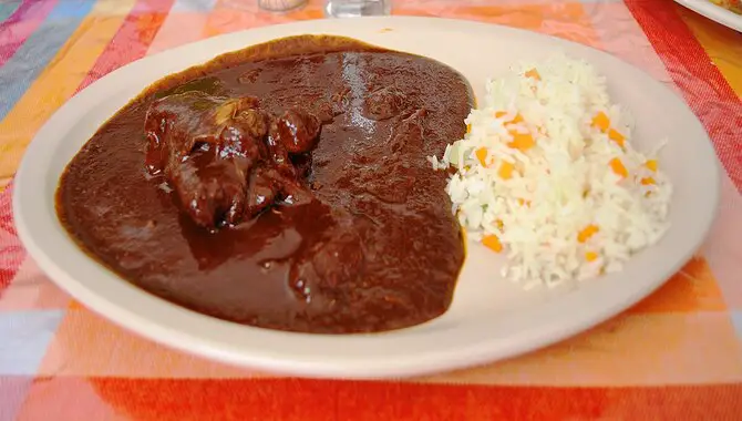 Serving And Enjoying The Mole Sauce