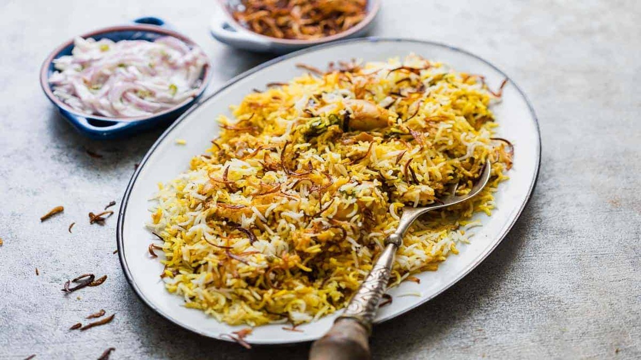 Serving And Enjoying Traditional Indian Biryani